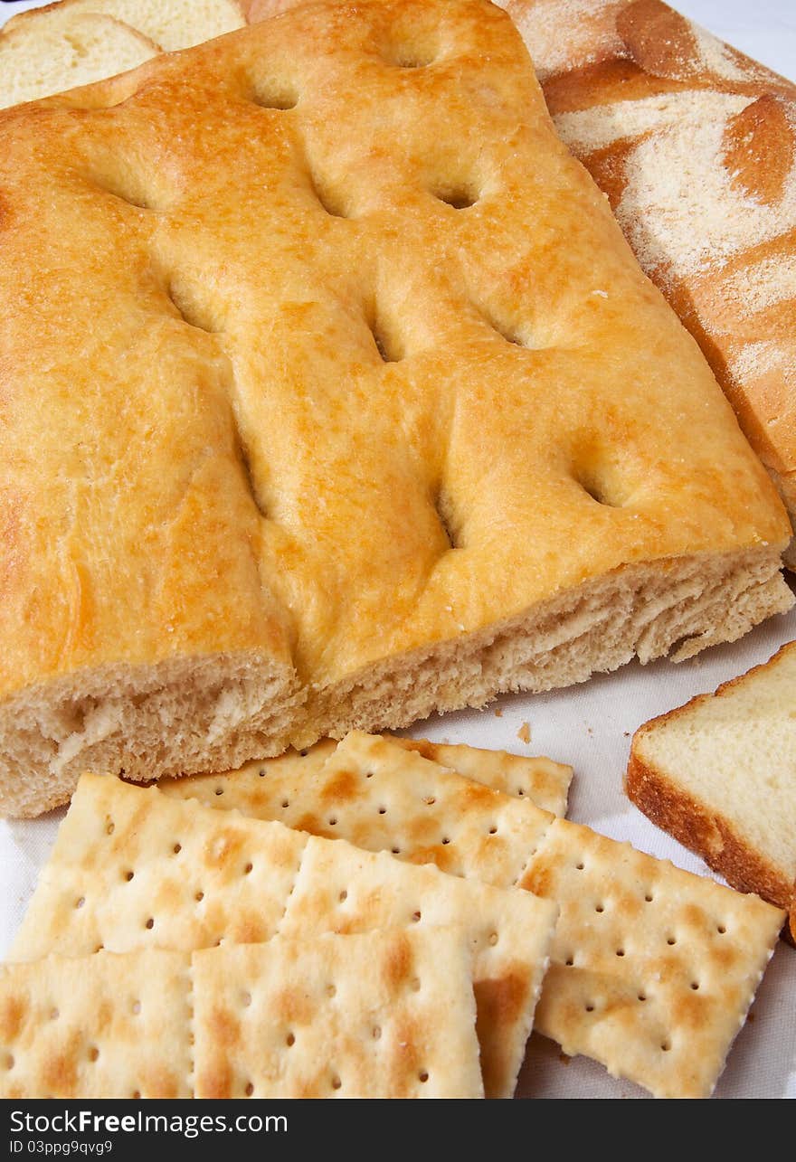 Close up genoese (or genovese) focaccia, bread and crackers. Close up genoese (or genovese) focaccia, bread and crackers