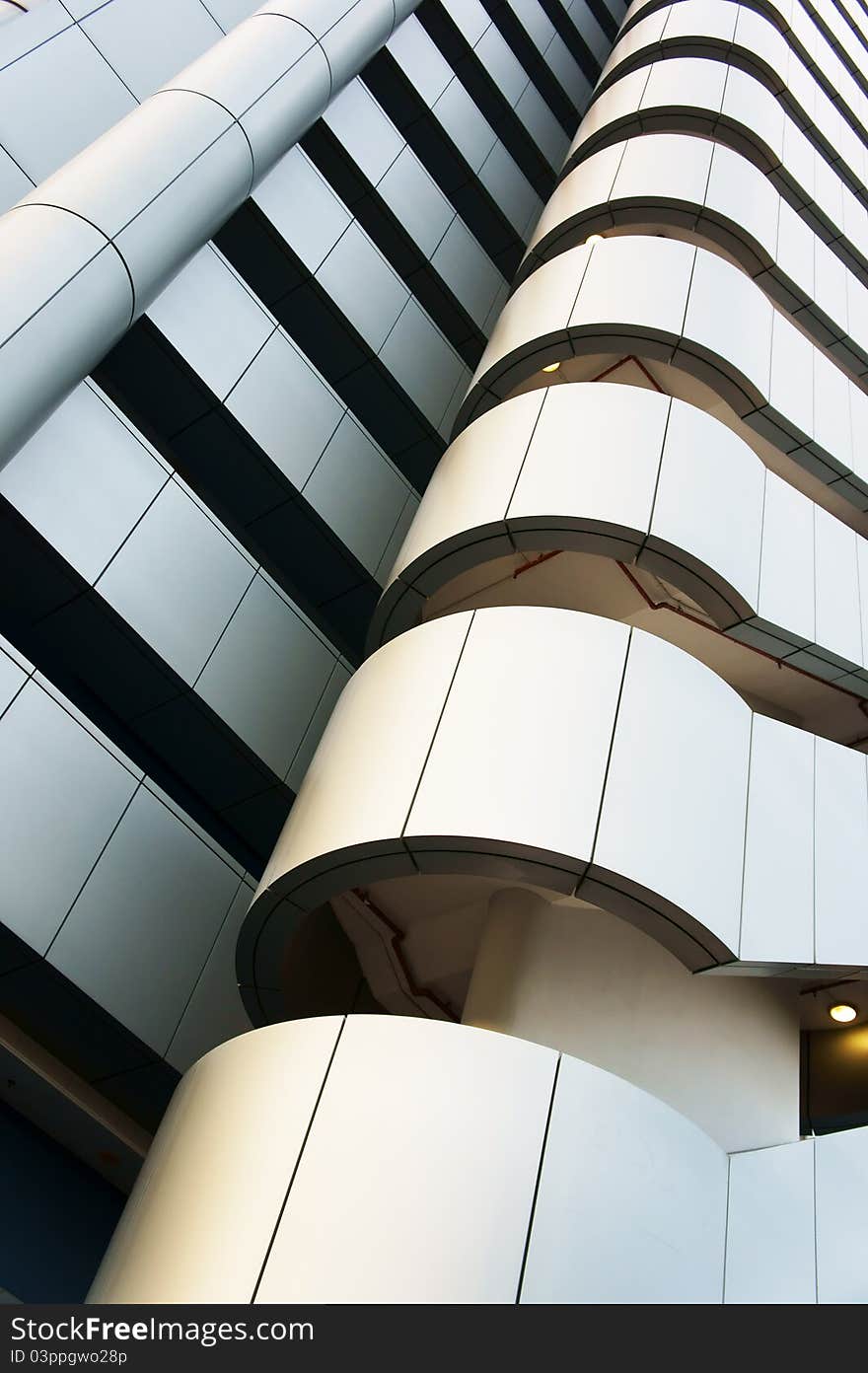 A low angle view of a modern building stairs with white metallic panels. A low angle view of a modern building stairs with white metallic panels