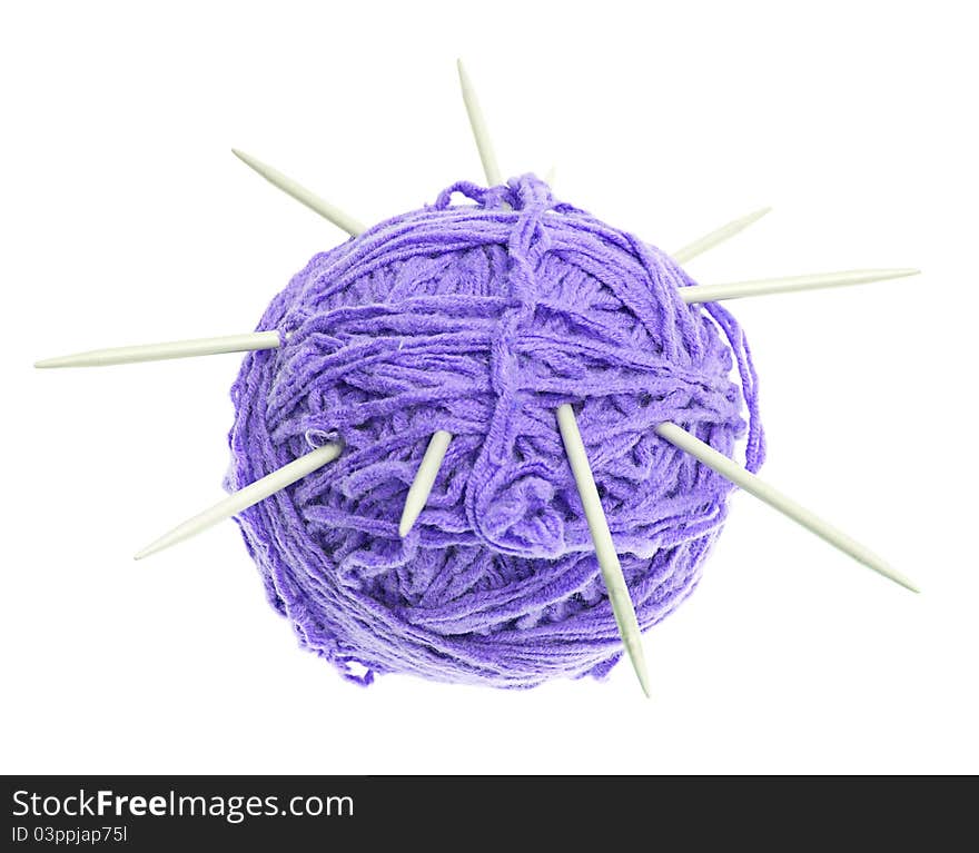 A ball of thread and knitting needles on a white background