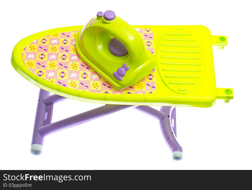 Toy iron and ironing board on white