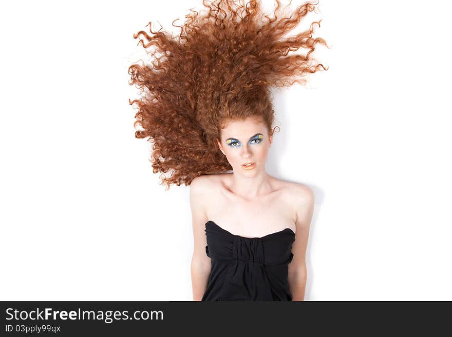 Young beautiful woman with long red curly hair lying on floor. Young beautiful woman with long red curly hair lying on floor