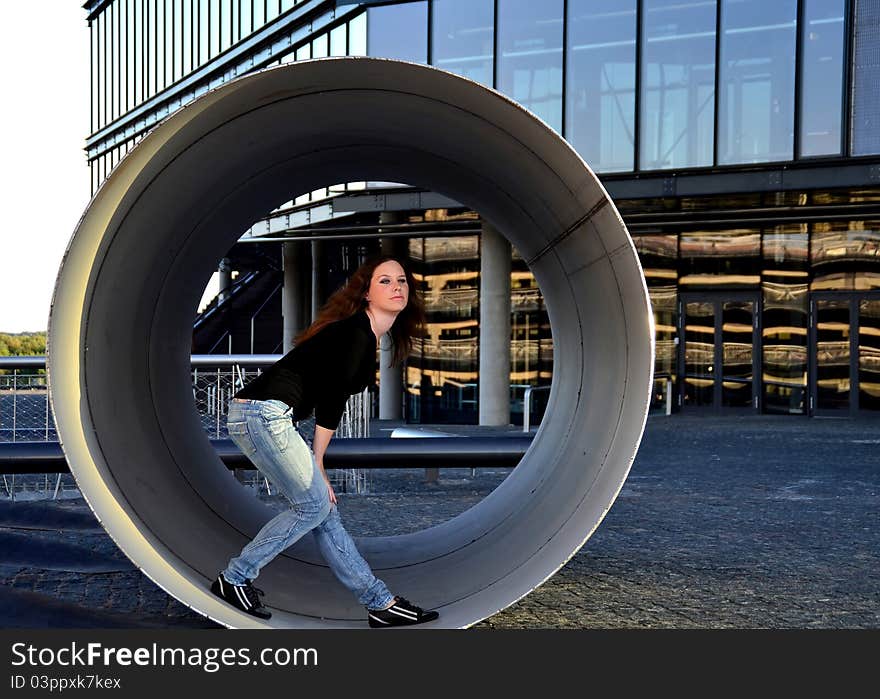 Girl standing inside the metallic pipe. Girl standing inside the metallic pipe