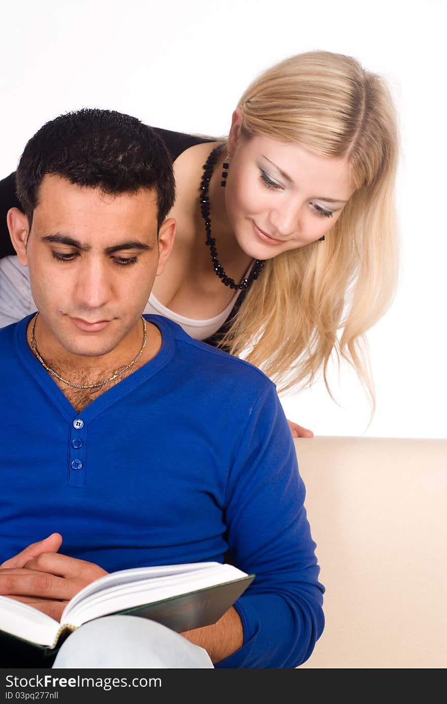 Portrait of a cute couple reading a book