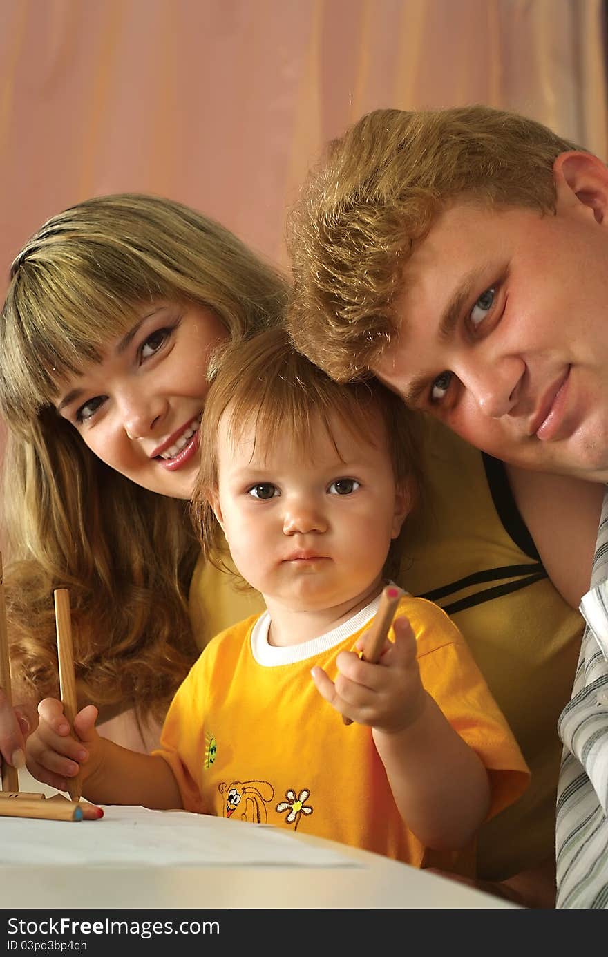 Portrait of a cute family drawing at table