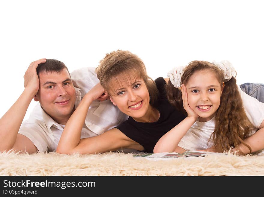 Cute family of a three lying on carpet. Cute family of a three lying on carpet