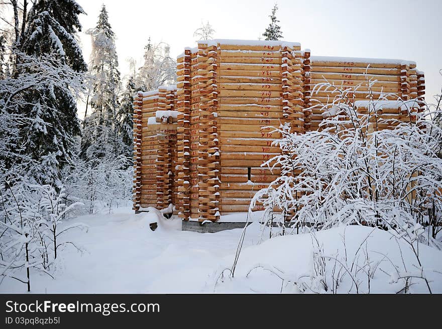 Unfinished abandoned wooden country house covered in snow in winter time. Unfinished abandoned wooden country house covered in snow in winter time