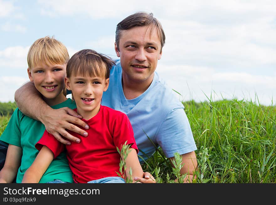 Dad with sons at field