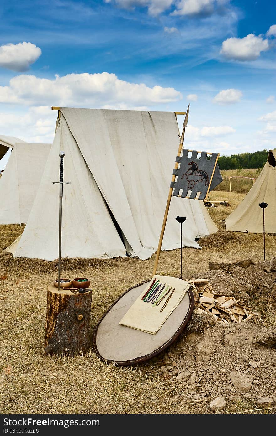 Sergiev Posad - August 27, 2011:sword and tents to the Festival of medieval culture Red Field in Sergiev Posad, Moscow Region, Russia - August 27, 2011. Sergiev Posad - August 27, 2011:sword and tents to the Festival of medieval culture Red Field in Sergiev Posad, Moscow Region, Russia - August 27, 2011