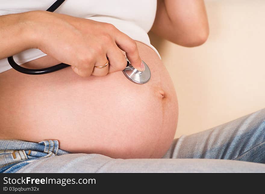 Pregnant woman with stethoscope