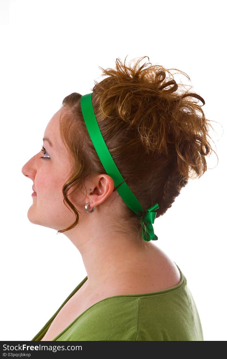 Young caucasian woman with an updo hair style on bright background