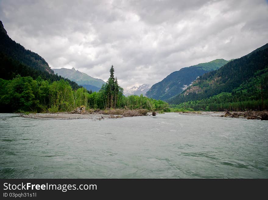 The river in a valley between mountains