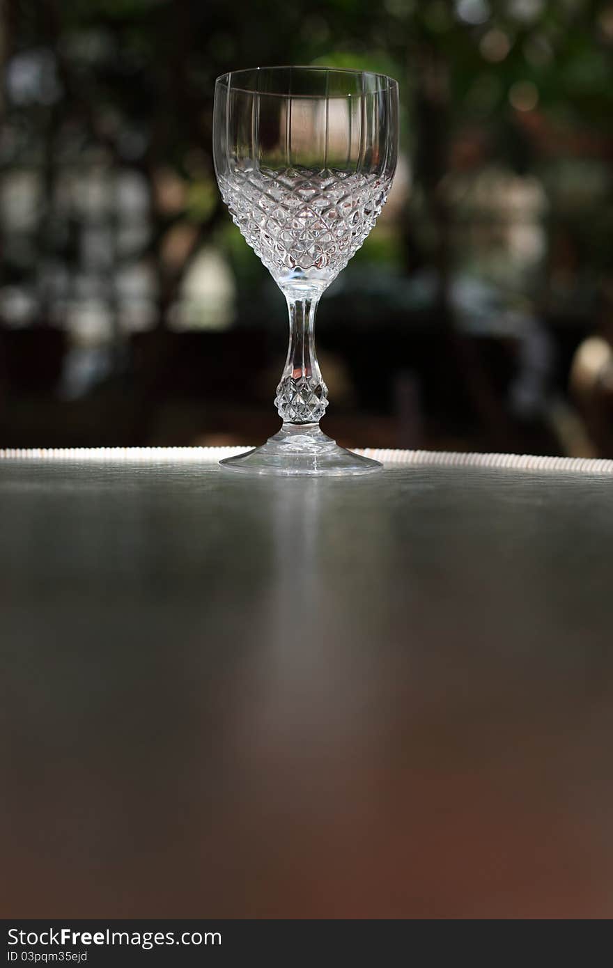 Crystal wine glass on the mirror table