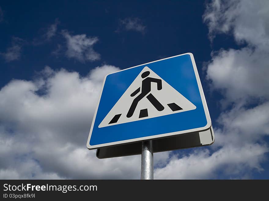 Crosswalk road sign on a sky background