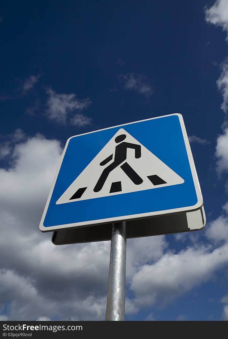 Crosswalk road sign on a sky background