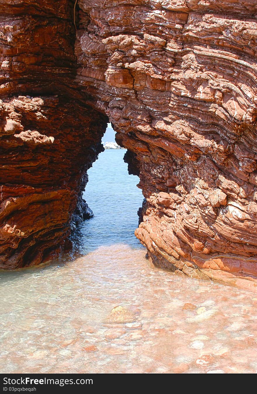 A hole in the mountain running into the sea