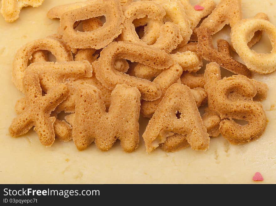 Studio-shot of preparing and baking cookies for christmas. baked letter biscuits spelling out the word xmas. Studio-shot of preparing and baking cookies for christmas. baked letter biscuits spelling out the word xmas.