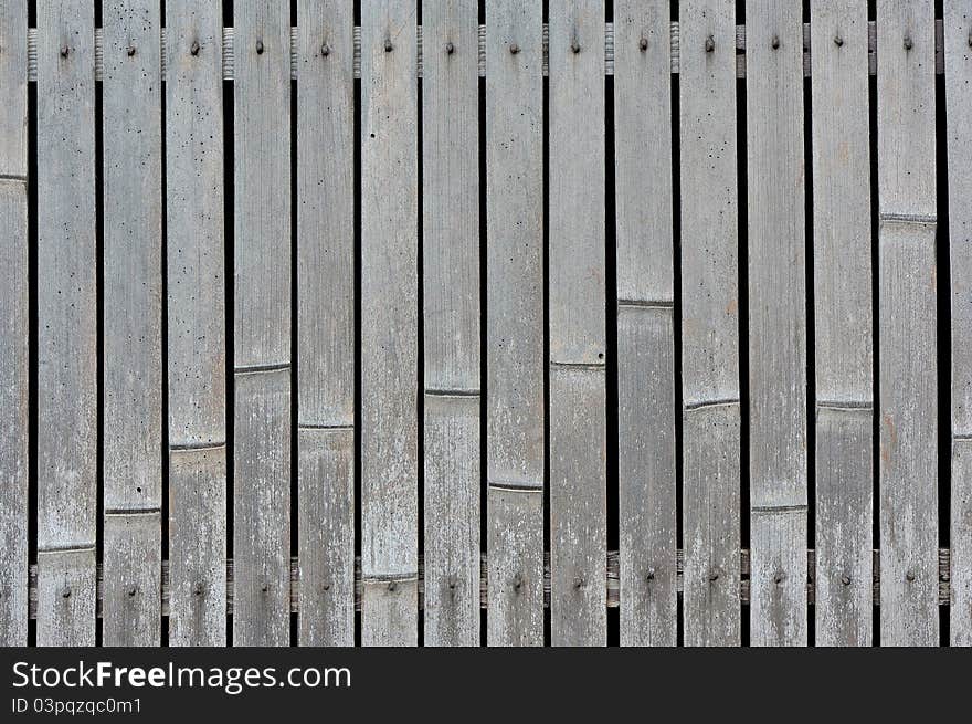 A close up shot of a wall made of bamboo. A close up shot of a wall made of bamboo.