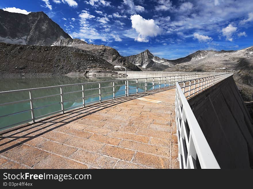 Dam and man-made lake between mountains. It’s Venerocolo Lake, North of Italy, Lombardy region, at 2.540 meters on the sea-level. Dam and man-made lake between mountains. It’s Venerocolo Lake, North of Italy, Lombardy region, at 2.540 meters on the sea-level