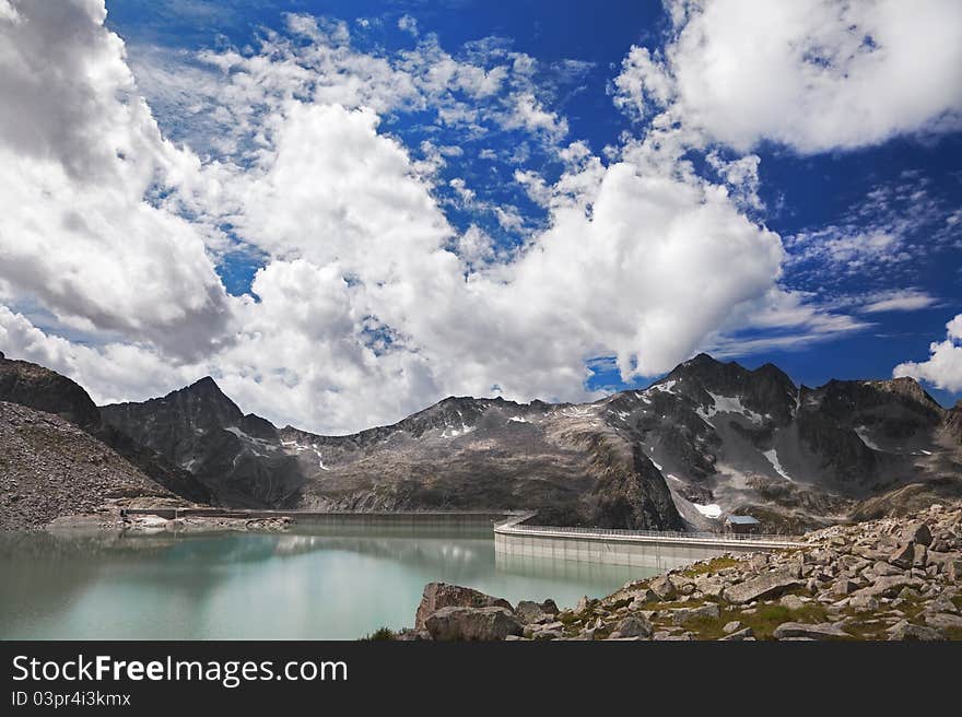 Dam and man-made lake between mountains. It’s Venerocolo Lake, North of Italy, Lombardy region, at 2.540 meters on the sea-level. Dam and man-made lake between mountains. It’s Venerocolo Lake, North of Italy, Lombardy region, at 2.540 meters on the sea-level