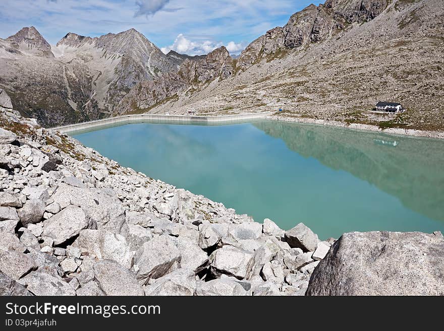 Dam and man-made lake between mountains. It’s Venerocolo Lake, North of Italy, Lombardy region, at 2.540 meters on the sea-level. Dam and man-made lake between mountains. It’s Venerocolo Lake, North of Italy, Lombardy region, at 2.540 meters on the sea-level