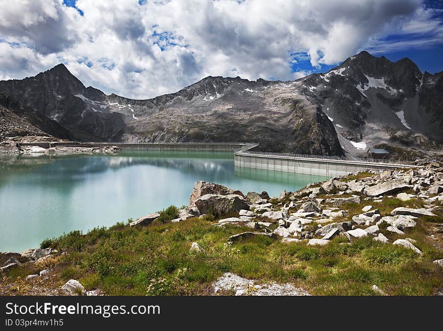 Dam and man-made lake between mountains. It’s Venerocolo Lake, North of Italy, Lombardy region, at 2.540 meters on the sea-level. Dam and man-made lake between mountains. It’s Venerocolo Lake, North of Italy, Lombardy region, at 2.540 meters on the sea-level