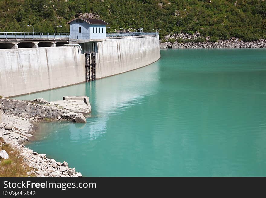 Dam and man-made lake between mountains. It’s Avio Lake, North of Italy, Lombardy region, at 1.923 meters on the sea-level. Dam and man-made lake between mountains. It’s Avio Lake, North of Italy, Lombardy region, at 1.923 meters on the sea-level