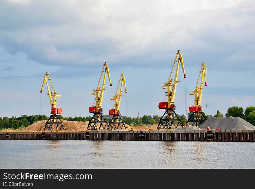 Cranes and sand hills on river port