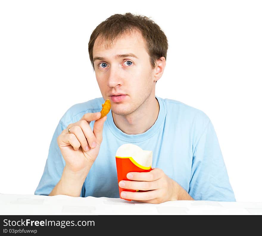 A young man with fries on a white