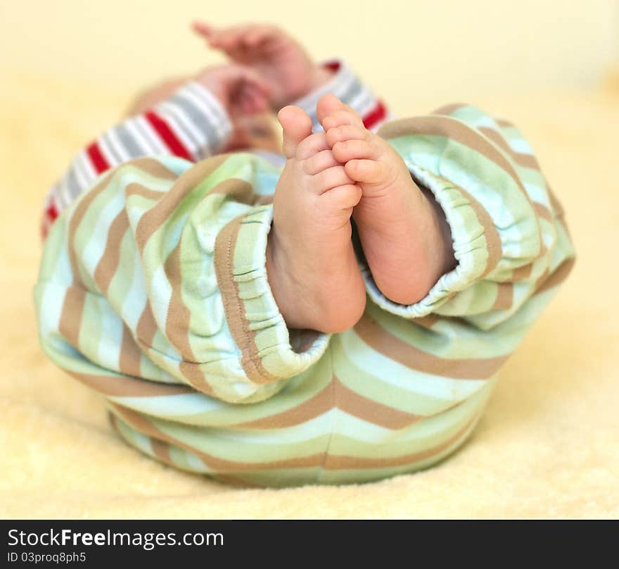 Cute baby foots in striped pants