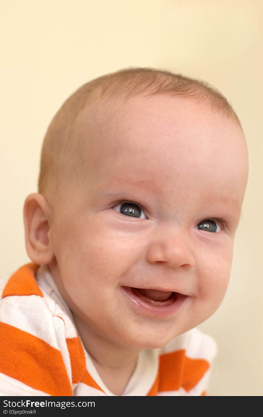 Portrait of cute baby boy in striped orange T-shirt. Portrait of cute baby boy in striped orange T-shirt