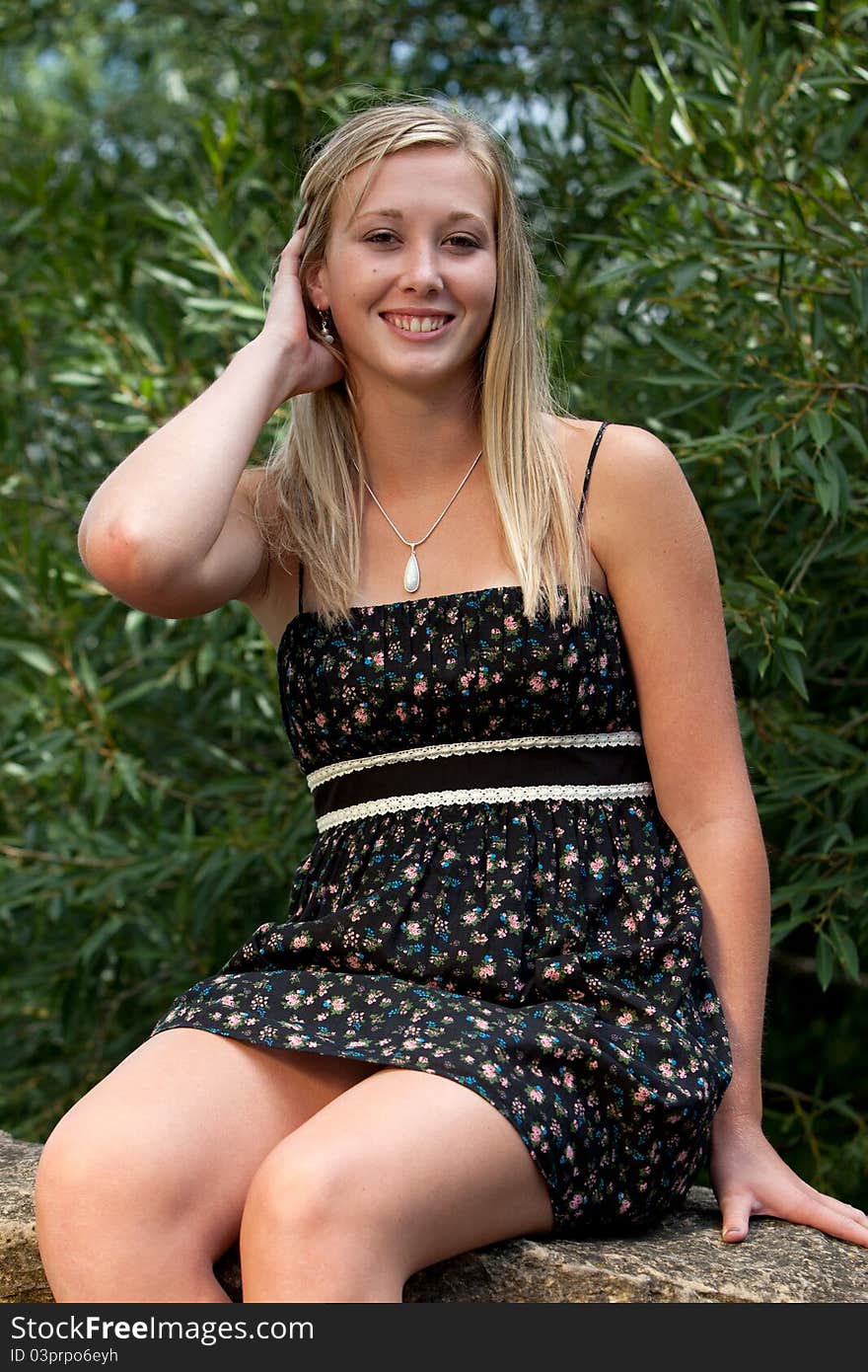 Beautiful blond model in dress playing with her hair