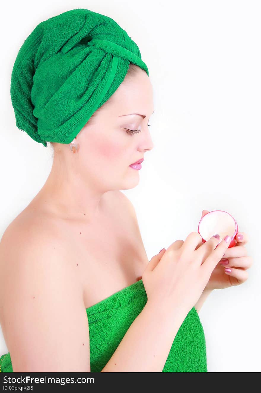 Girl rubs cream body on a white background