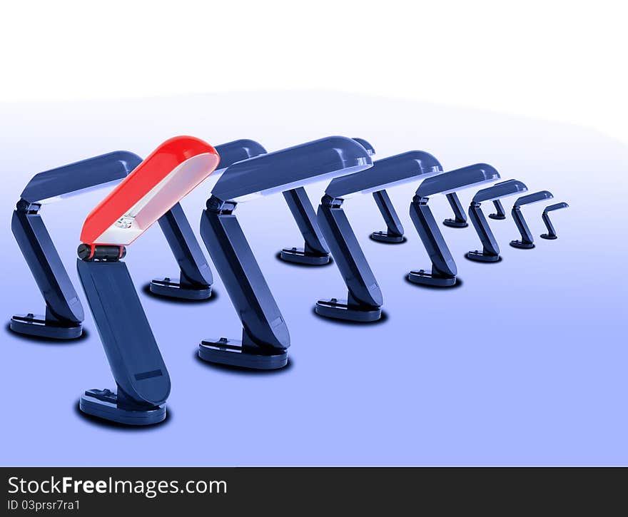 One red desk lamp near row of blue lamps standing on gradient background. One red desk lamp near row of blue lamps standing on gradient background