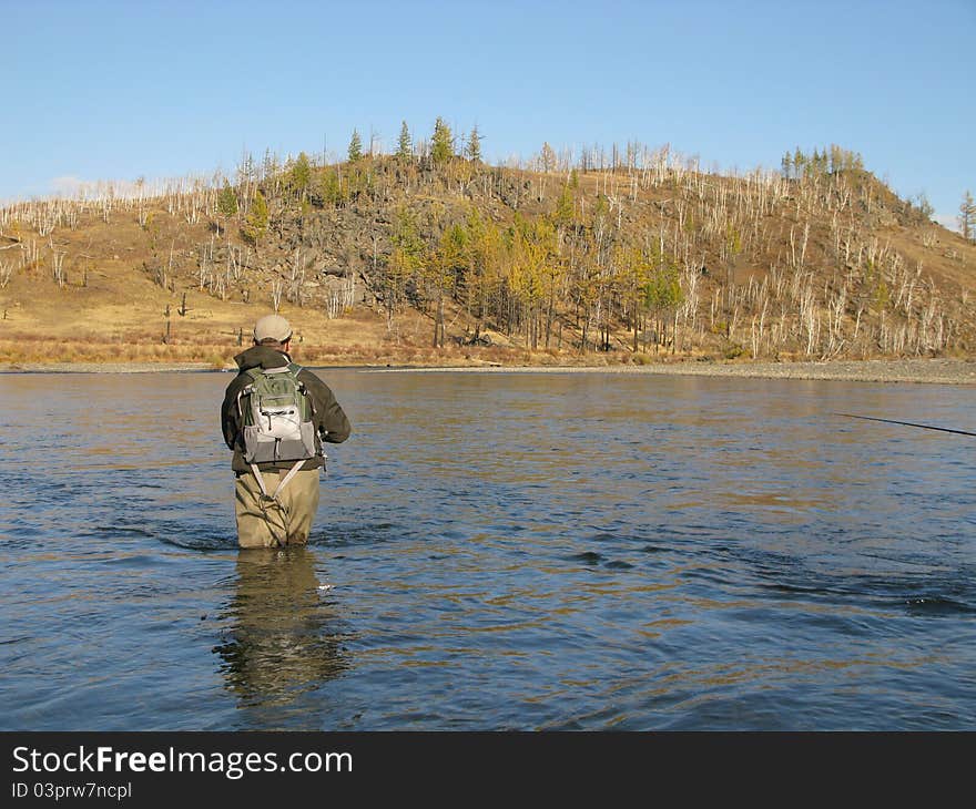 Fishing - fisherman on wild river