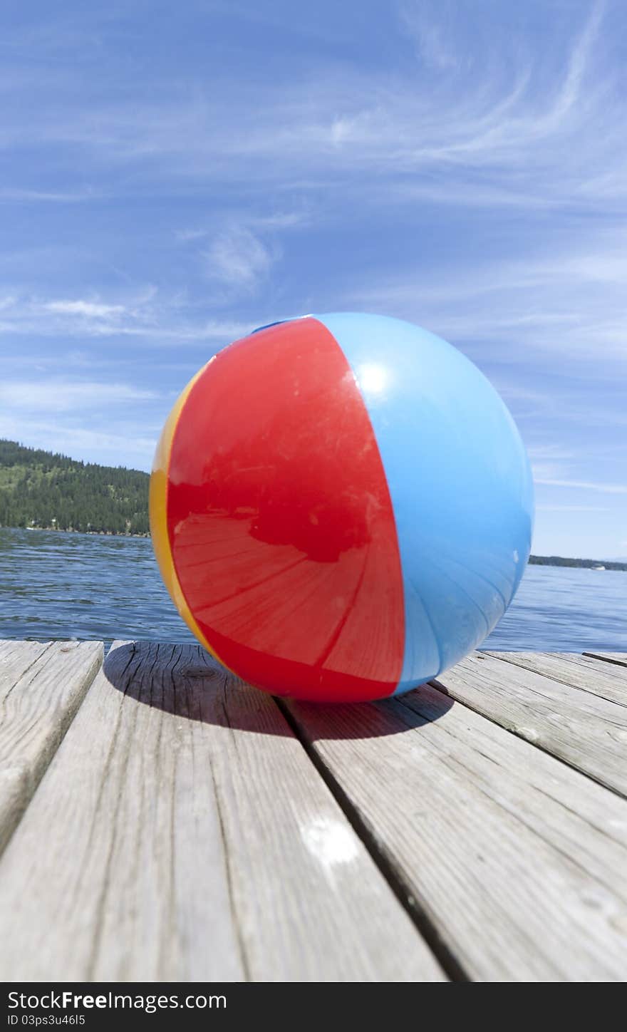 Colorful beachball on a dock