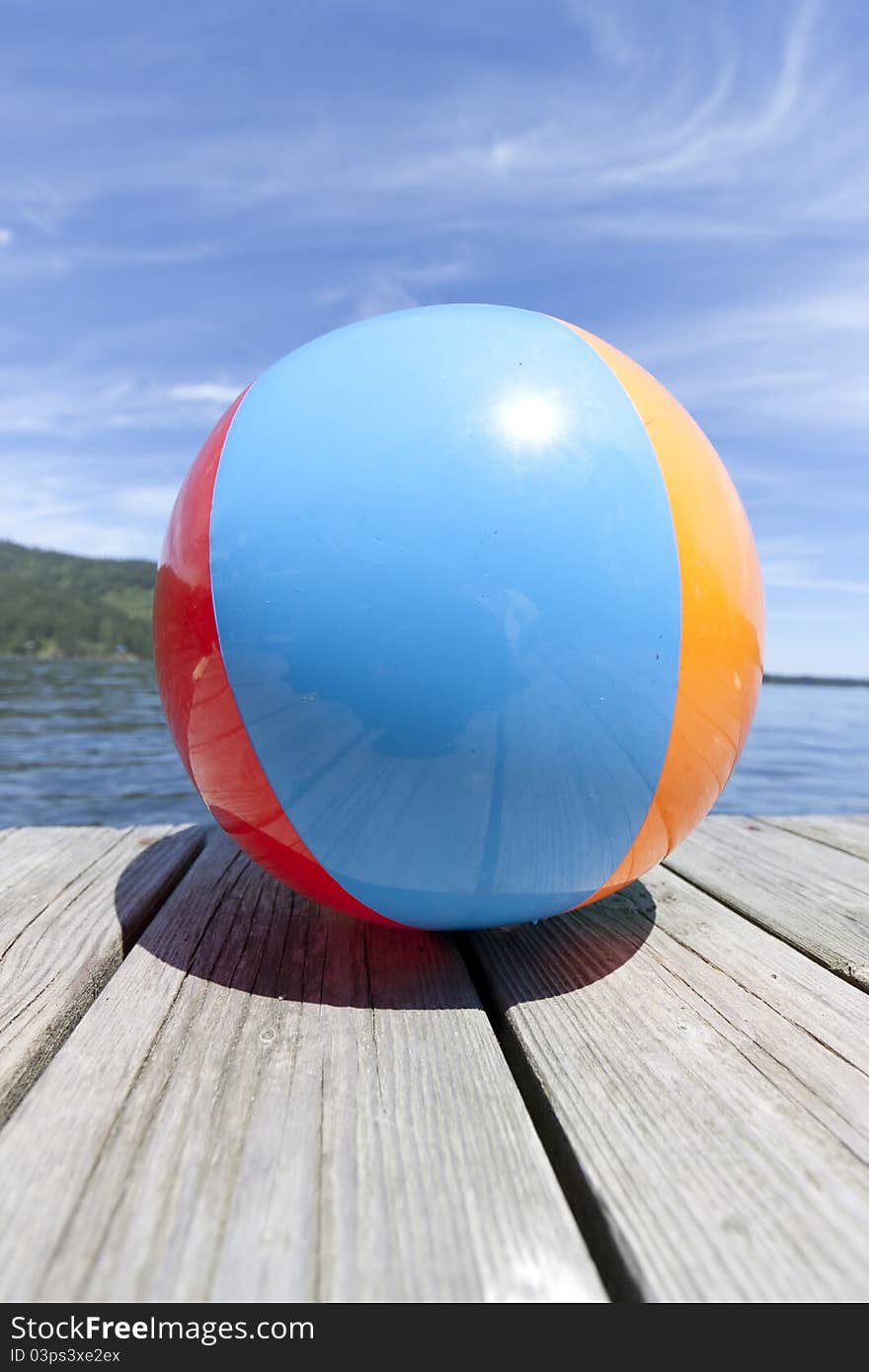 Colorful beachball on a dock