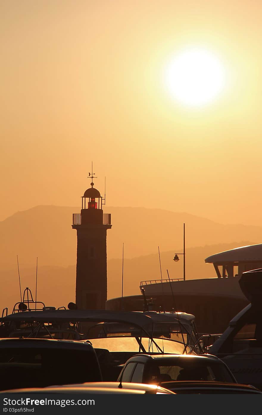 Lighthouse of saint tropez with ships in sunset