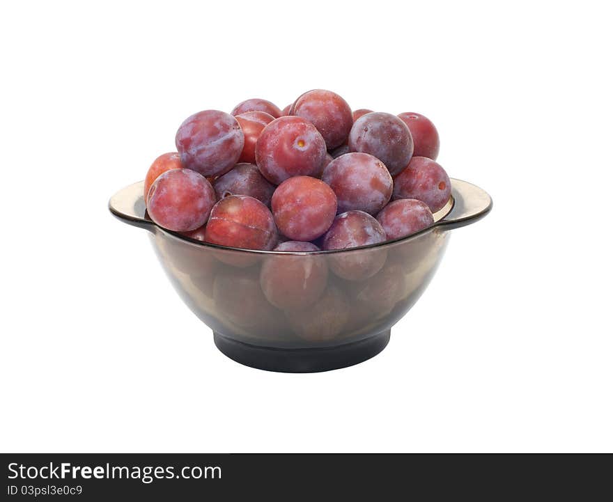 Ripe plums on a plate isolated on a white background. Ripe plums on a plate isolated on a white background.