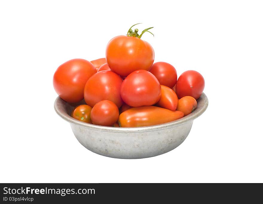 Tomatoes in an aluminum bowl, isolated on a white background. Tomatoes in an aluminum bowl, isolated on a white background.