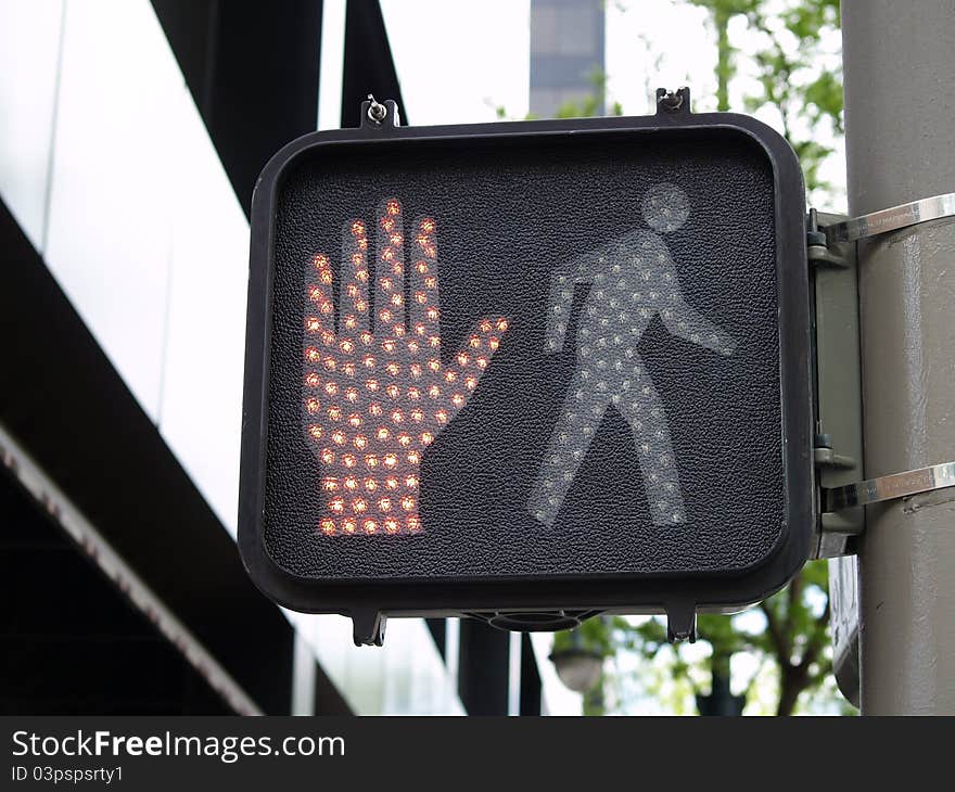 Modern crossing sign with stop hand showing. Modern crossing sign with stop hand showing.