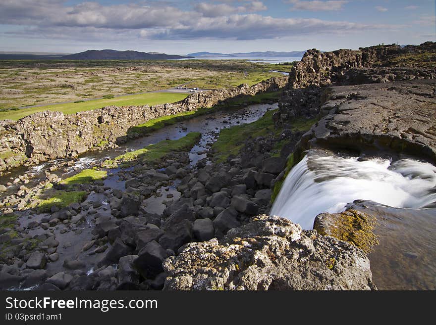 Þingvellir national park near Reykjavik is one of the most popular places of interest along so called Golden Ring - route from Reykjavik. This is where the American and Eurasian plates meet or better to say separate as they are drifting apart creating a canyon seen in the photo. This photo has been taken from above the Öxarárfoss waterfall. Þingvellir national park near Reykjavik is one of the most popular places of interest along so called Golden Ring - route from Reykjavik. This is where the American and Eurasian plates meet or better to say separate as they are drifting apart creating a canyon seen in the photo. This photo has been taken from above the Öxarárfoss waterfall.