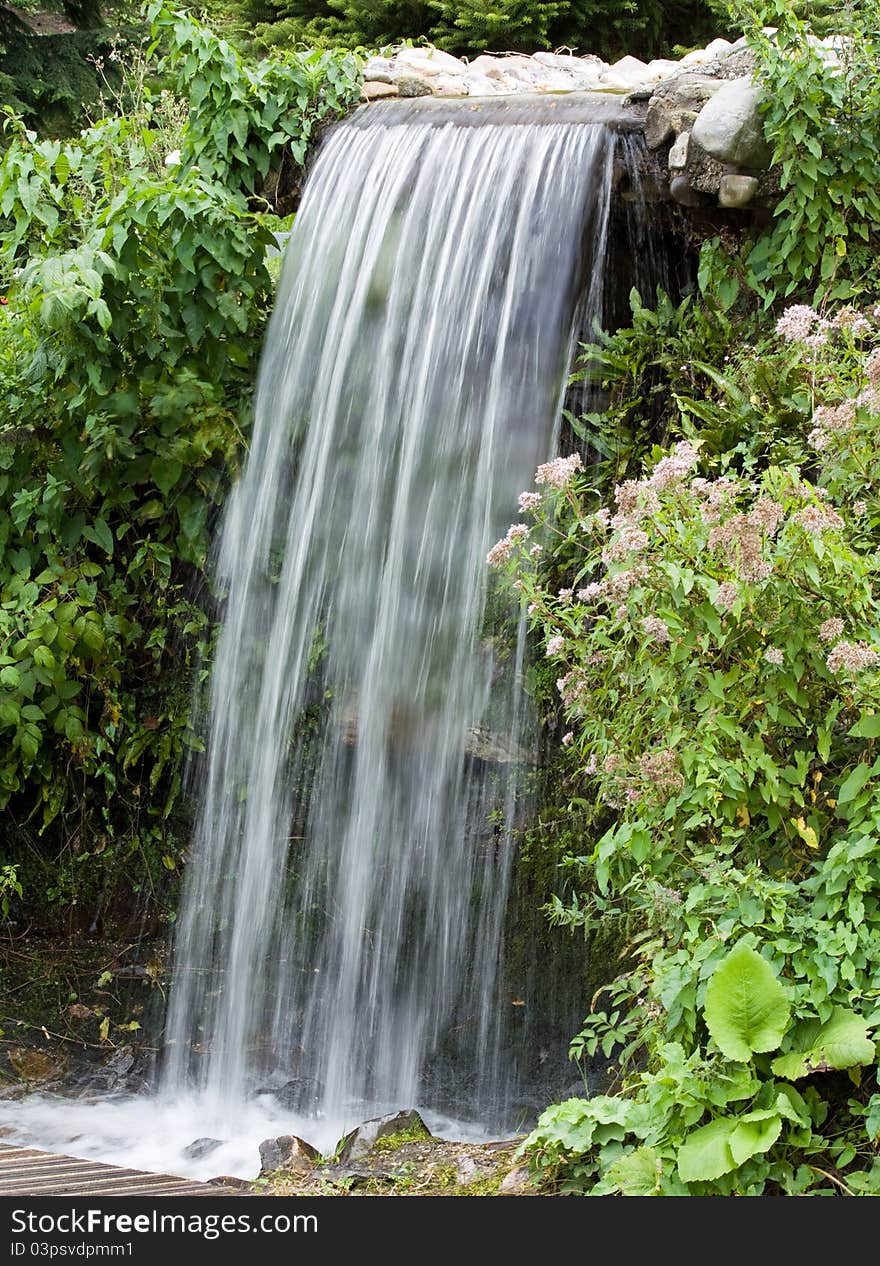 Beautiful waterfall between green vegetation