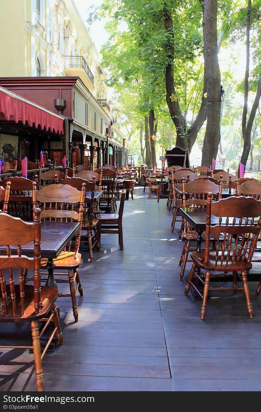 Empty sidewalk restaurant is photographed with diminishing perspective early in the morning. Empty sidewalk restaurant is photographed with diminishing perspective early in the morning.