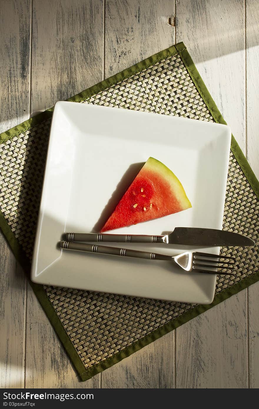 Melon slice on a white plate. Melon slice on a white plate