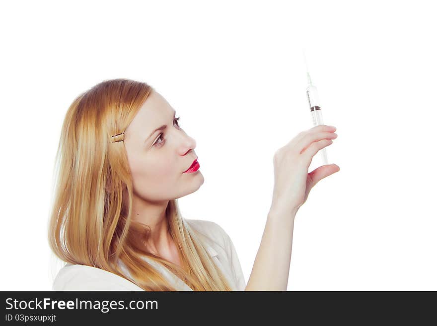 Pretty nurse with syringe in medical white uniform