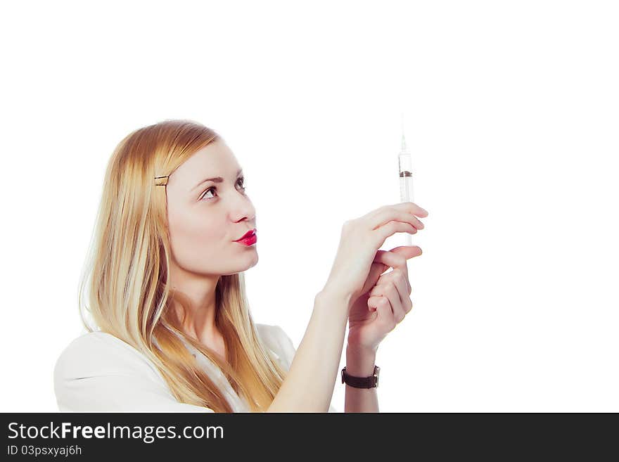 Pretty nurse with syringe in medical white uniform