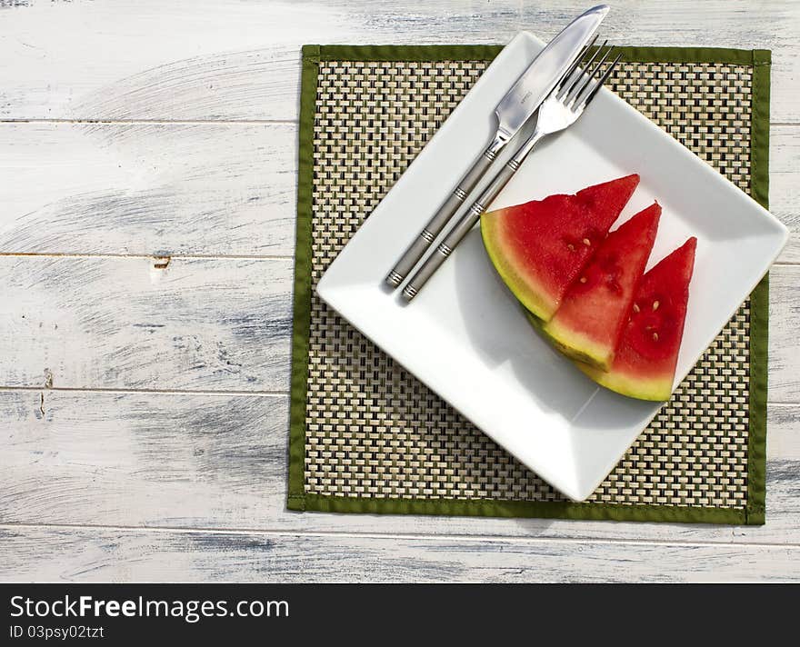 Melon slices on a white plate