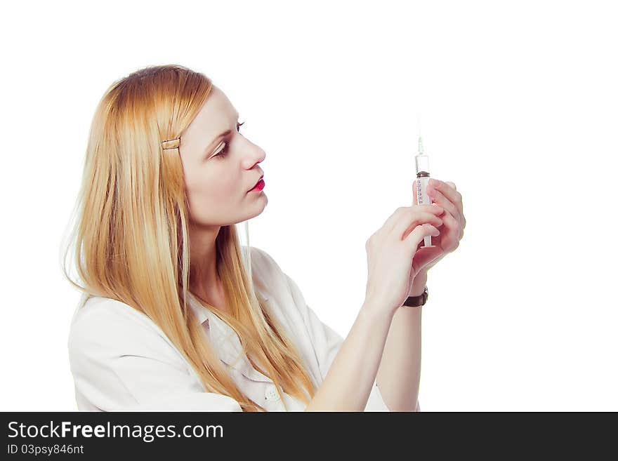 Pretty nurse with syringe in medical white uniform