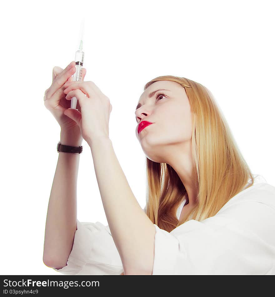 Pretty nurse with syringe in medical white uniform