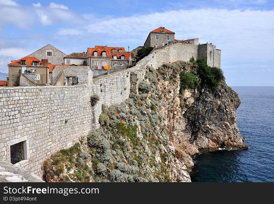 Landscape of Dubrovnik citywalls next to the open sea. Landscape of Dubrovnik citywalls next to the open sea.